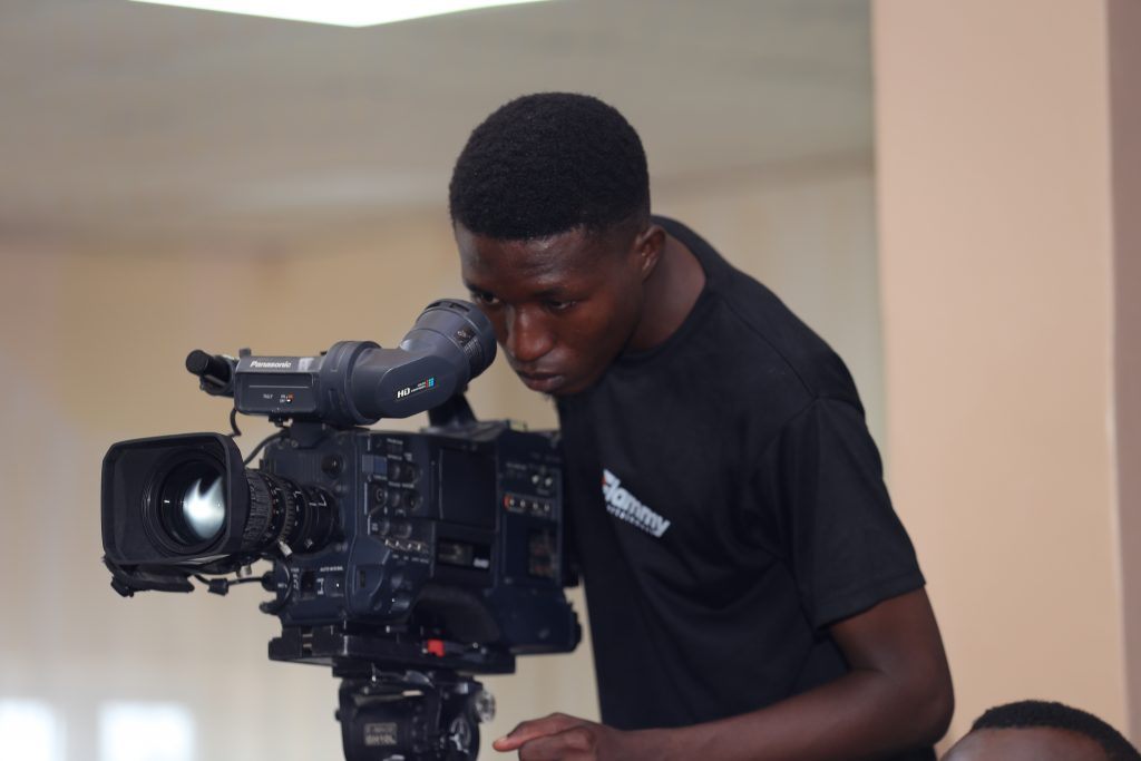 A Flammy crew member operating a cinema camera