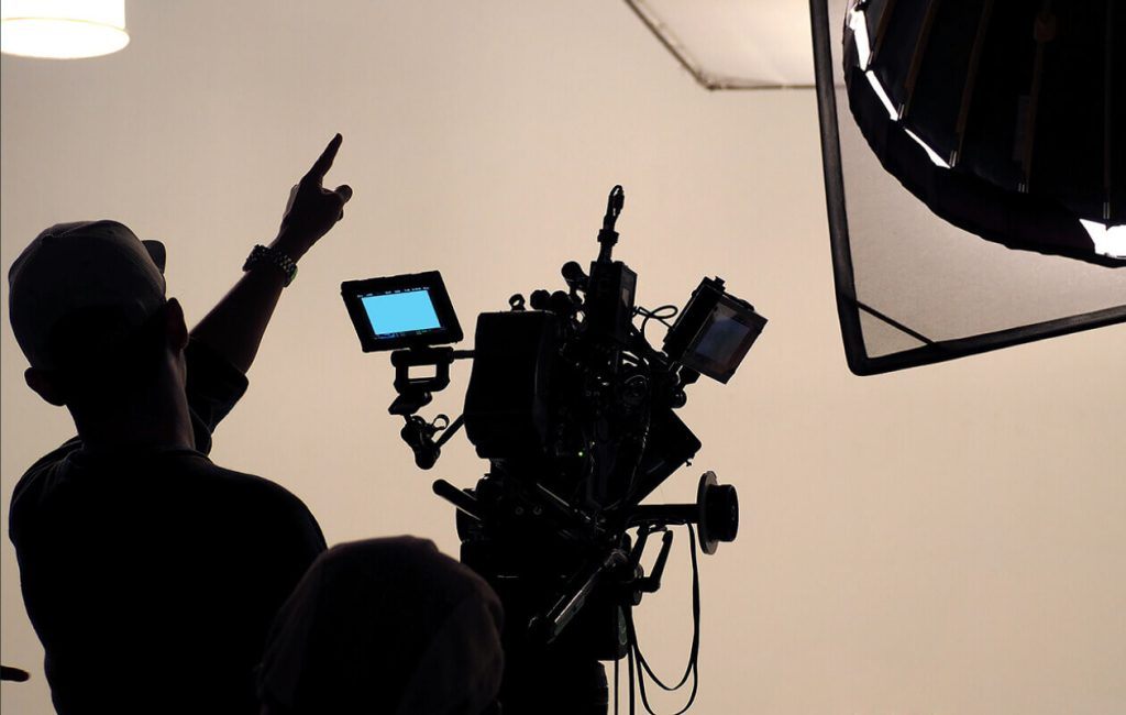 A crew member preparing a camera on set